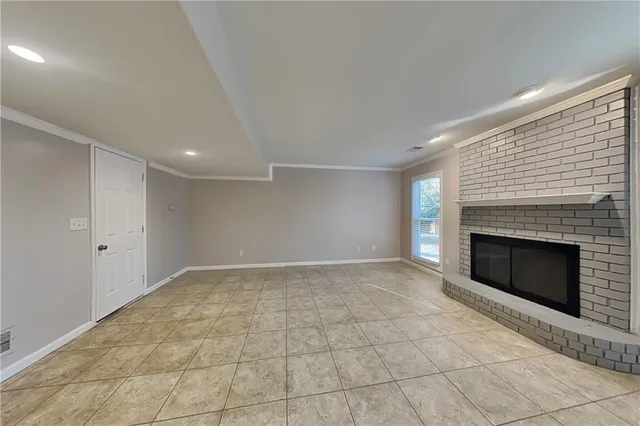 a view of an empty room with a fireplace