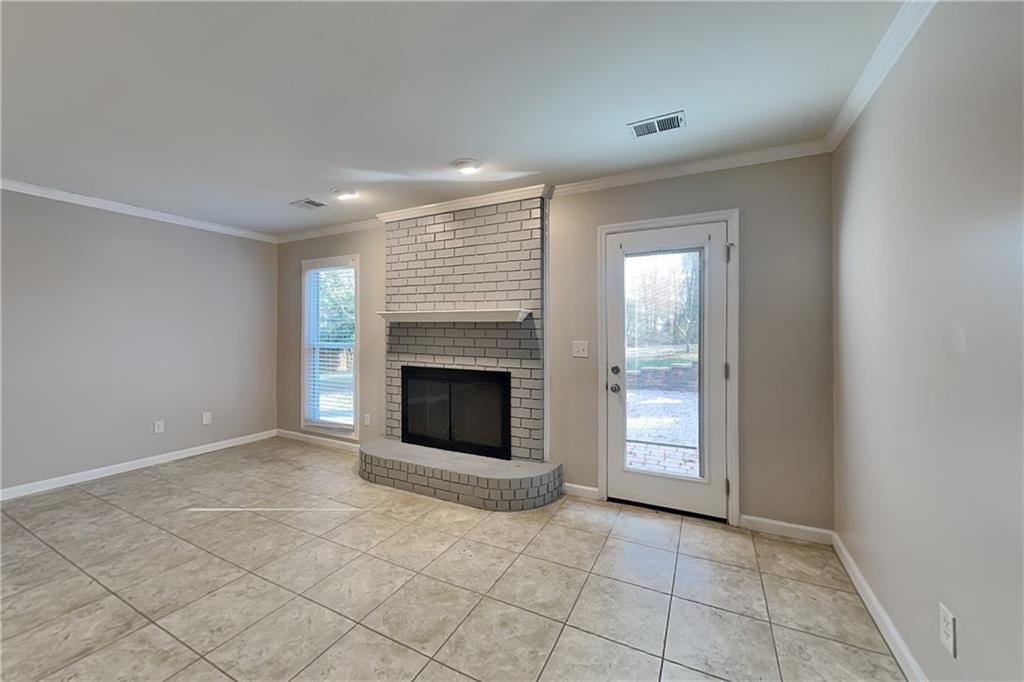 1916 Beckett Drive Marietta, GA 30062 - Photo 4 of 20 a view of an empty room with a fireplace and a window