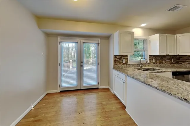 a view of a kitchen with granite countertop cabinets