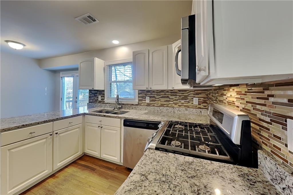 1916 Beckett Drive Marietta, GA 30062 - Photo 6 of 20 a kitchen with sink stove and cabinets