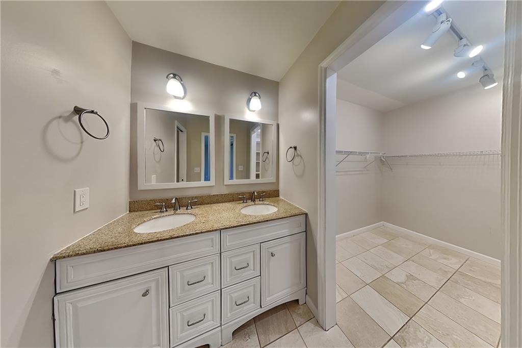 1916 Beckett Drive Marietta, GA 30062 - Photo 9 of 20 a bathroom with a granite countertop sink a mirror and a shower