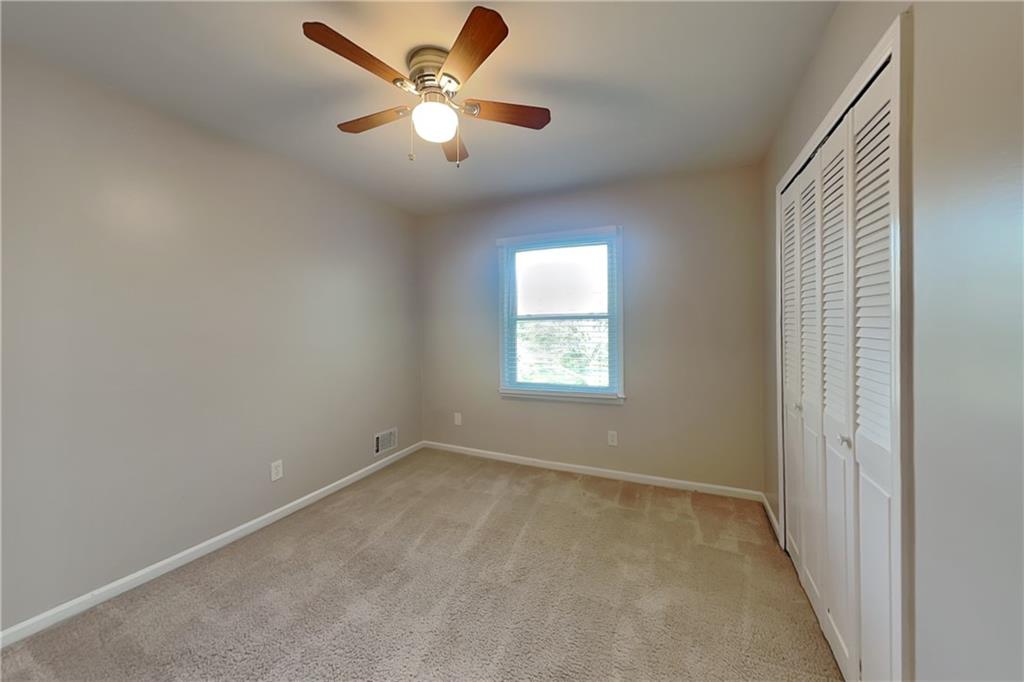 1916 Beckett Drive Marietta, GA 30062 - Photo 10 of 20 an empty room with a window and a fan