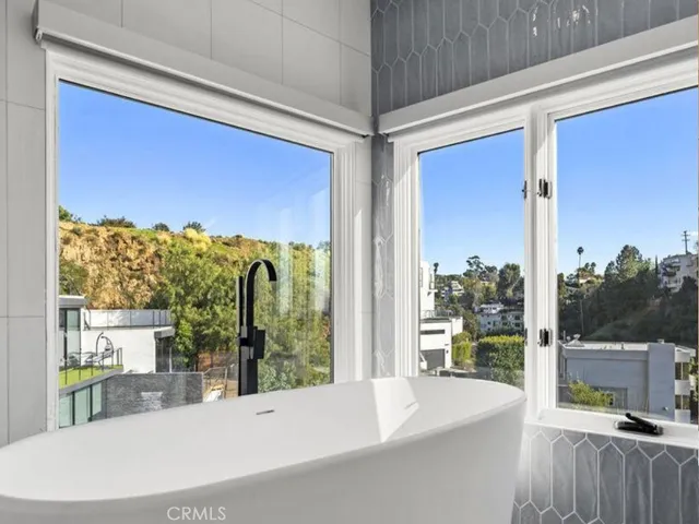 a kitchen with a stove and white cabinets