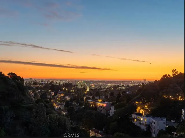 a view of city and mountain from a balcony
