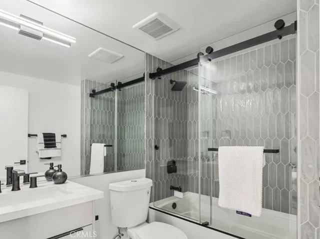 a large bed sitting in a bedroom and a table