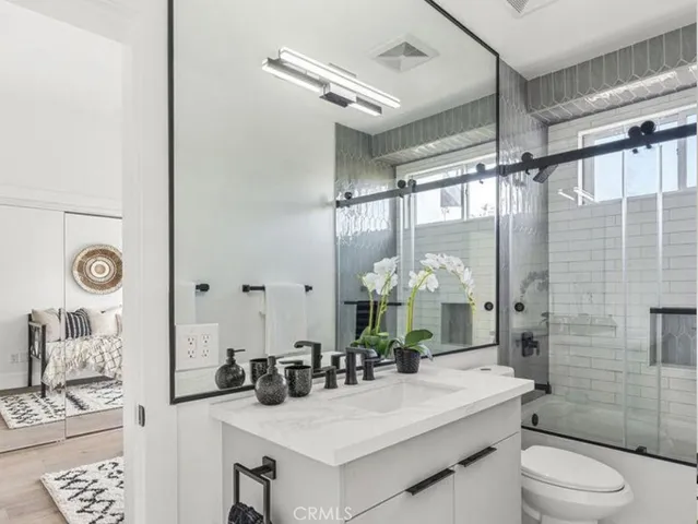 a bedroom with furniture and a potted plant