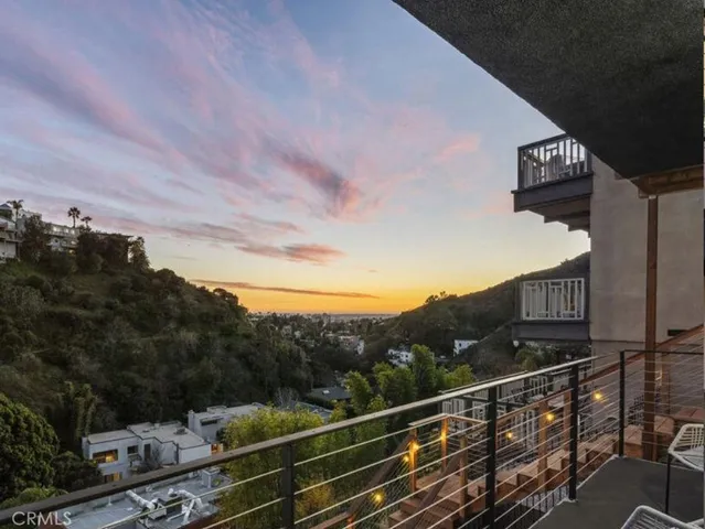 a front view of a building with table and chairs