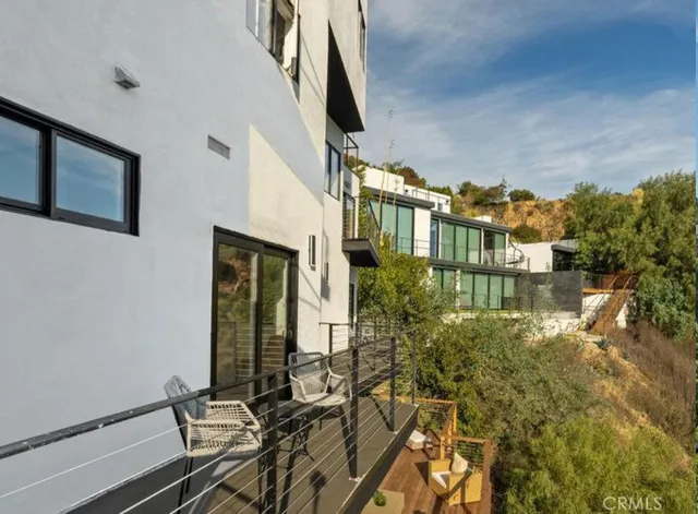 an aerial view of residential houses with outdoor space and lake view