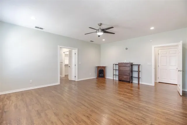 a view of kitchen with kitchen island wooden floor appliances and living room