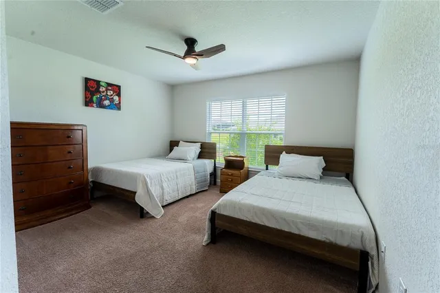 a bedroom with two beds and window