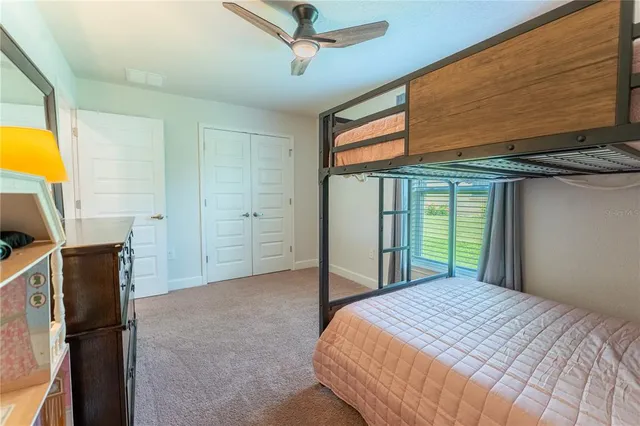 a bedroom with a bed dresser and a window