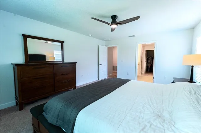 a bedroom with a bed and a dresser