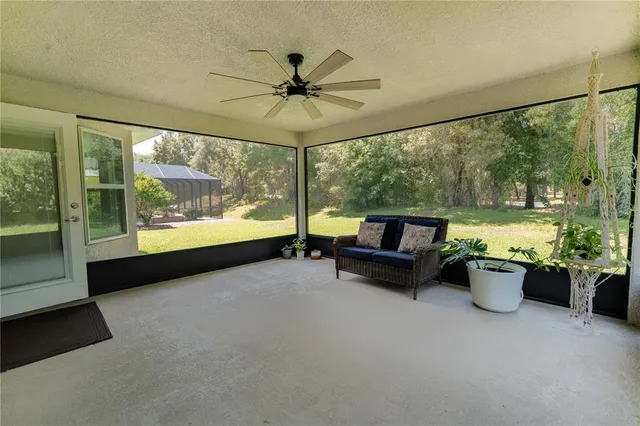 a living room with furniture and a floor to ceiling window
