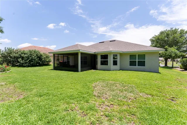 a view of a house with a backyard