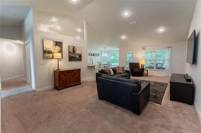 a living room with furniture windows and flat screen tv