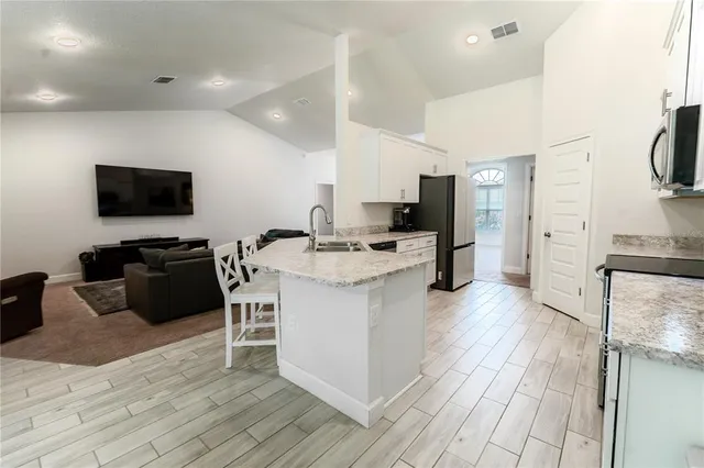 a kitchen with a sink appliances and cabinets