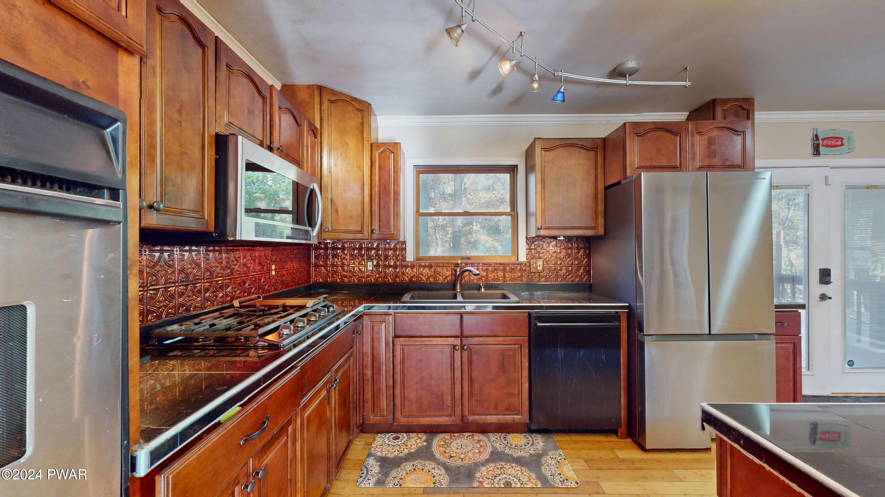 102 Maple Ridge Road Milford, PA 18337 - Photo 10 of 52 a kitchen with stainless steel appliances granite countertop a refrigerator and a stove