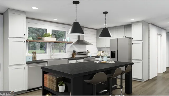 a kitchen with stainless steel appliances granite countertop a sink a refrigerator and a stove