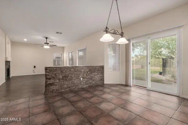 a kitchen with stainless steel appliances kitchen island granite countertop a refrigerator a stove a sink dishwasher with a dining table and chairs