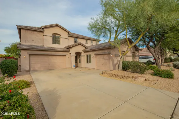 a front view of a house with a yard and garage