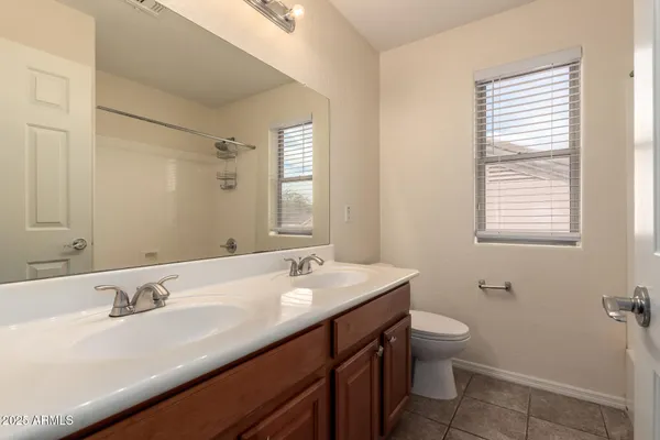 an empty room with a window and a ceiling fan