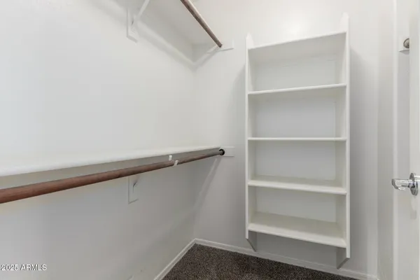 an empty room with closet and windows