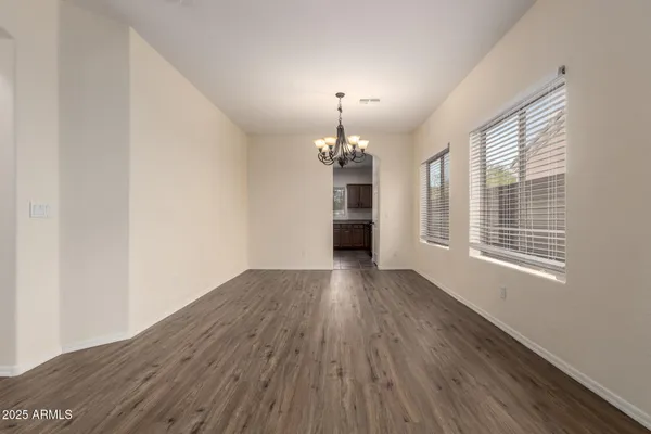 a view of a room with wooden floor and chandelier