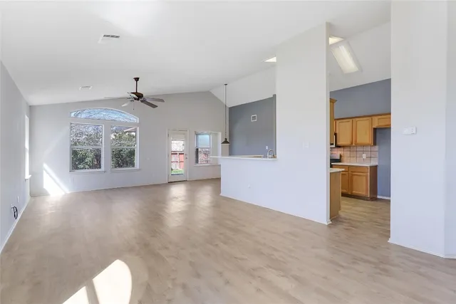a view of a kitchen with a sink and a window