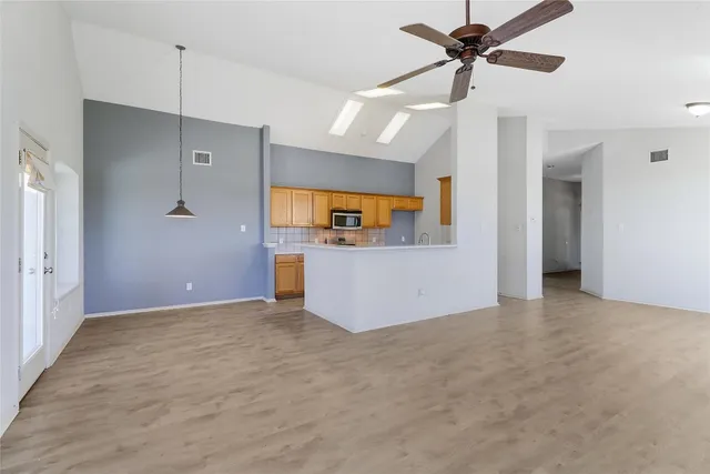 a kitchen with a sink stove and cabinets
