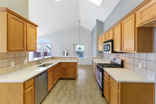 a view of a kitchen with a sink and cabinet area