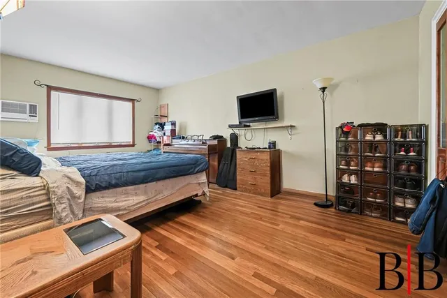 a bedroom with bed and flat screen tv