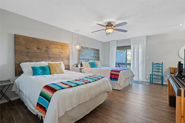 a bedroom with two beds and a chandelier