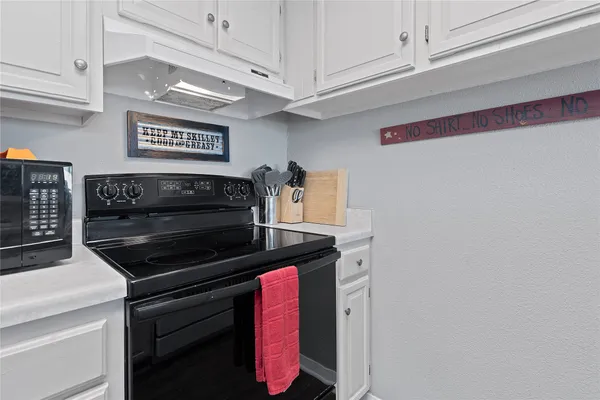 a kitchen with stainless steel appliances granite countertop a stove and a microwave