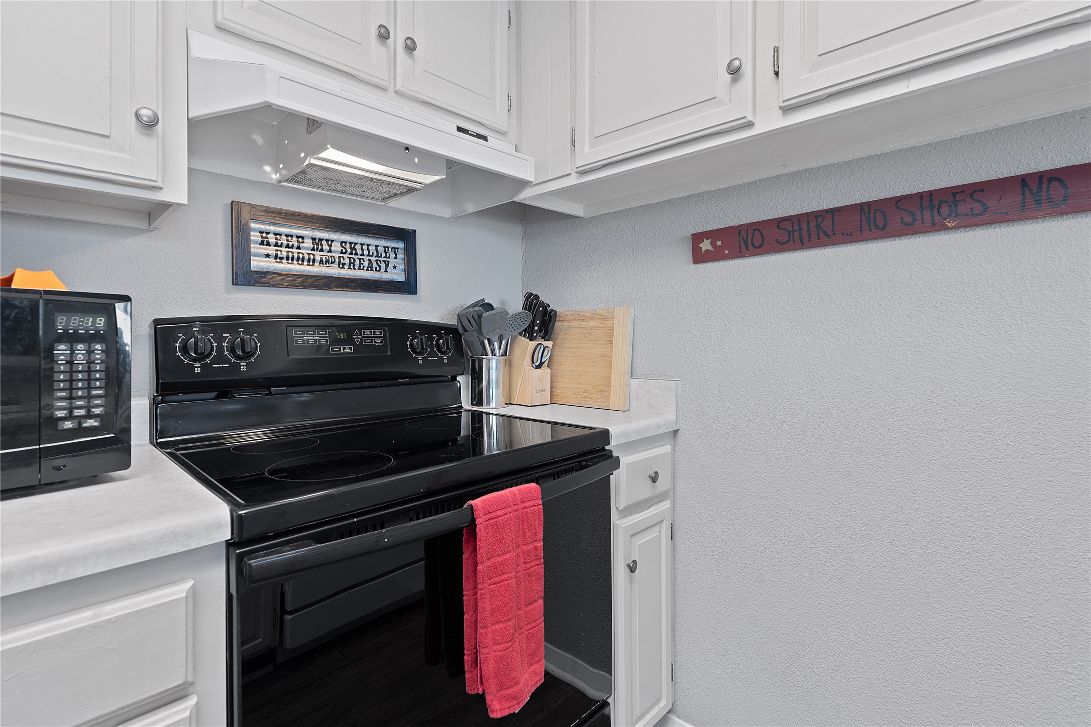 111 Comanche Drive Point Venture, TX 78645 - Photo 7 of 33 a kitchen with stainless steel appliances granite countertop a stove and a microwave