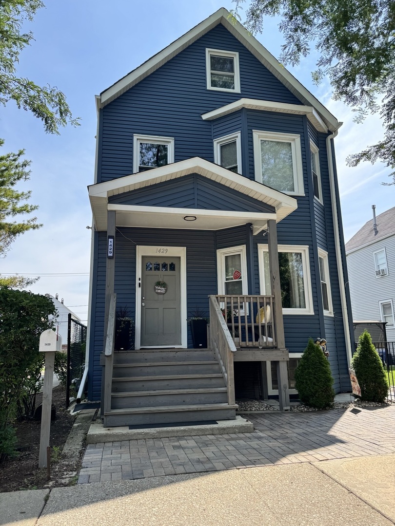 1429 South 49th Avenue, Unit 3 Cicero, IL 60804 - Photo 1 of 8 a front view of a house with stairs