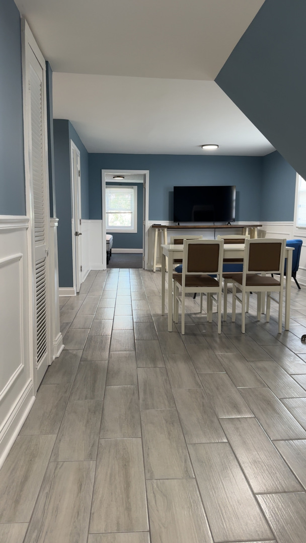 1429 South 49th Avenue, Unit 3 Cicero, IL 60804 - Photo 2 of 8 a living room with furniture a flat screen tv and kitchen view