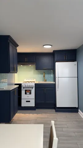 a kitchen with stainless steel appliances granite countertop a refrigerator a sink and a stove
