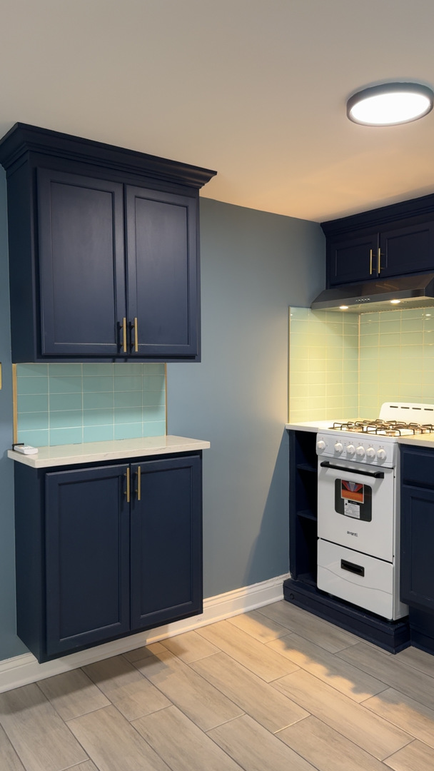 1429 South 49th Avenue, Unit 3 Cicero, IL 60804 - Photo 5 of 8 a kitchen with stainless steel appliances wooden cabinets and stove top oven