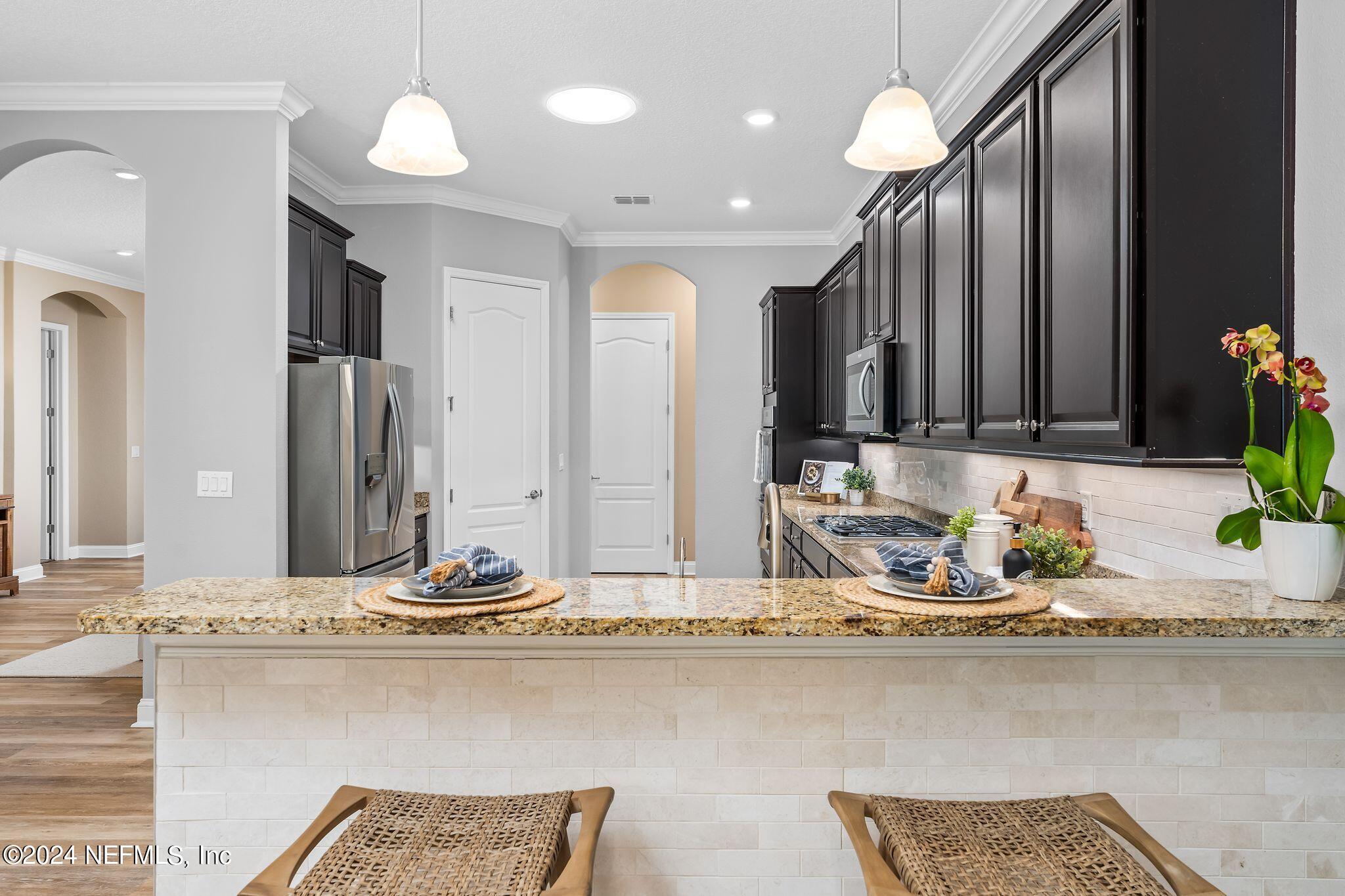 206 Medio Drive St. Augustine, FL 32095 - Photo 12 of 57 a bathroom with a granite countertop sink and a mirror