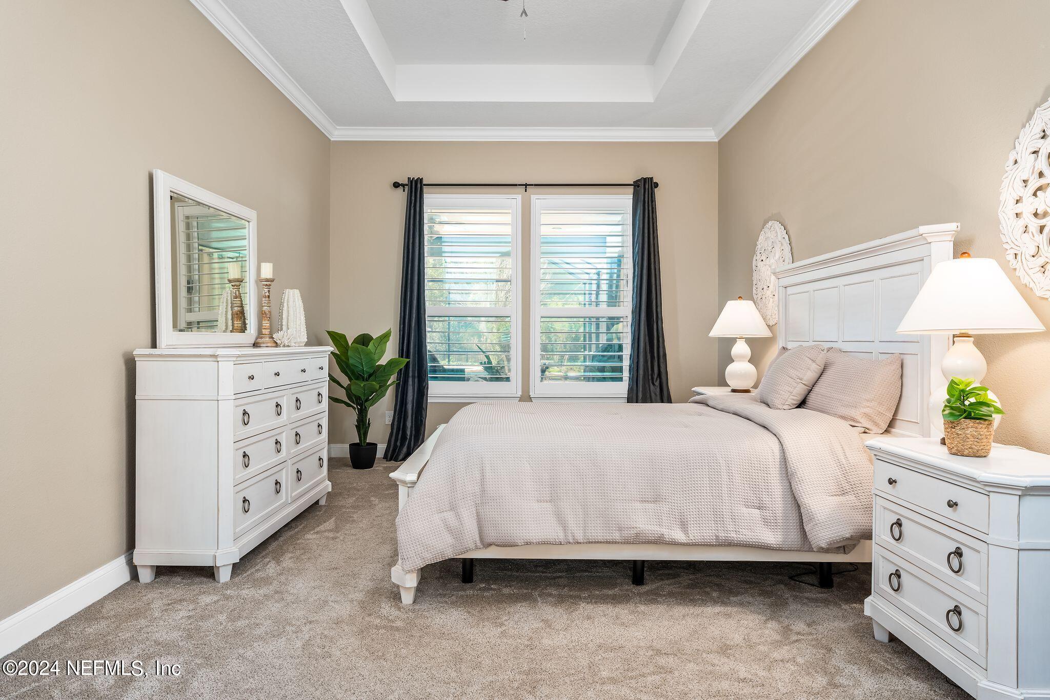 206 Medio Drive St. Augustine, FL 32095 - Photo 16 of 57 a bedroom with a bed and a dresser