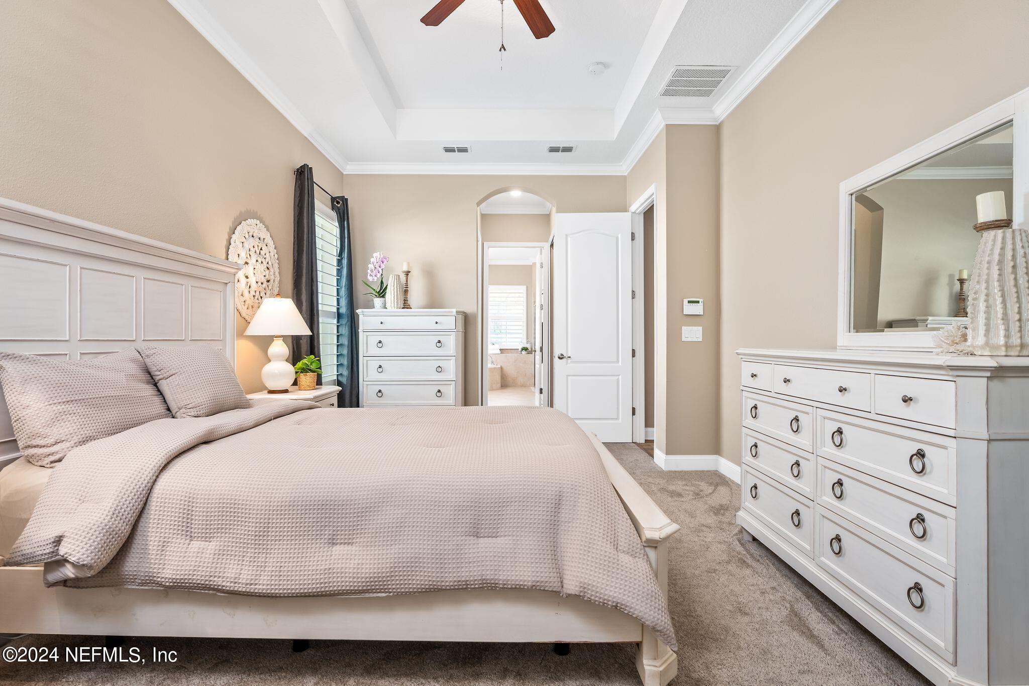 206 Medio Drive St. Augustine, FL 32095 - Photo 17 of 57 a bedroom with a bed and a dresser