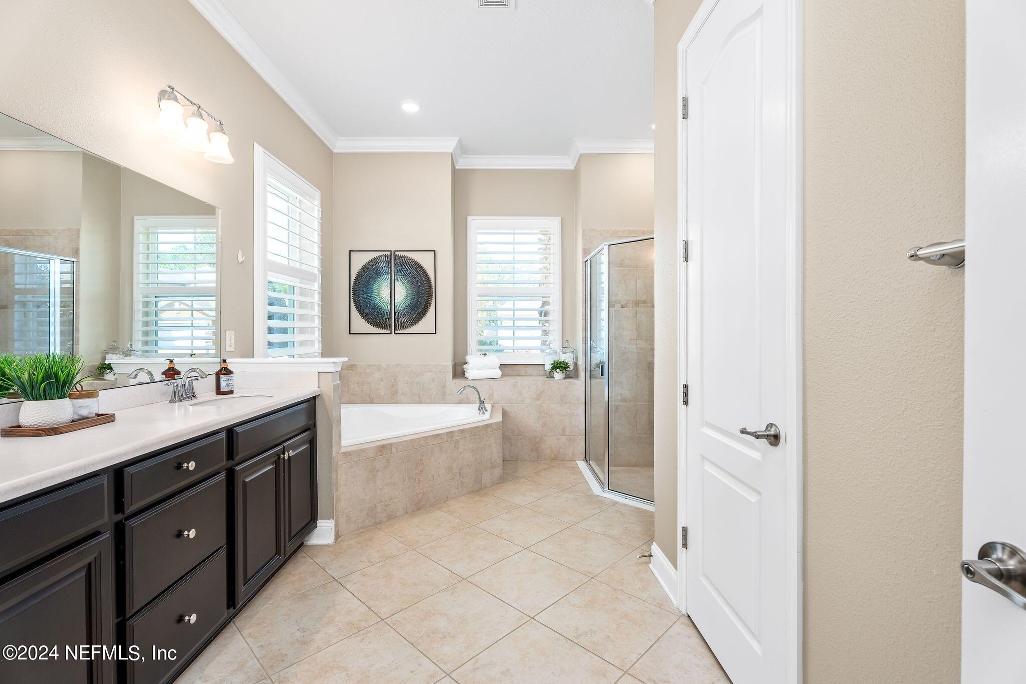 206 Medio Drive St. Augustine, FL 32095 - Photo 18 of 57 a spacious bathroom with a tub sink and mirror