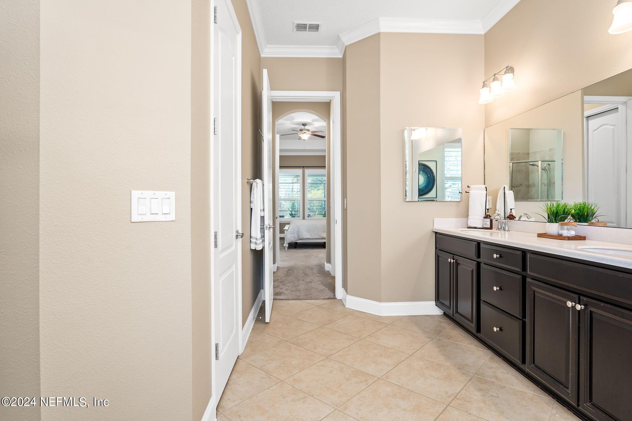 206 Medio Drive St. Augustine, FL 32095 - Photo 20 of 57 a spacious bathroom with a double vanity sink a large mirror and a shower