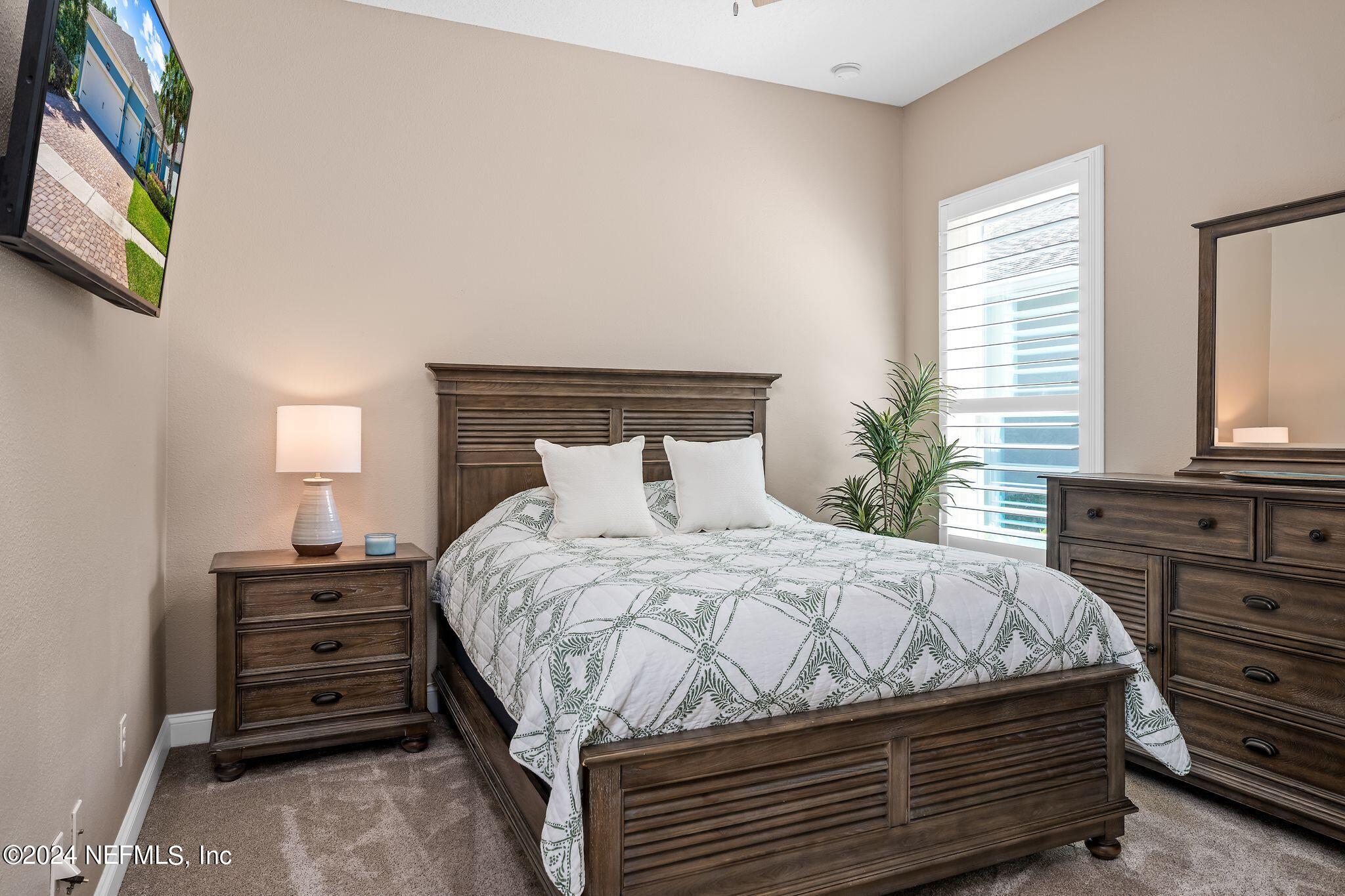 206 Medio Drive St. Augustine, FL 32095 - Photo 21 of 57 a bedroom with a bed and a window