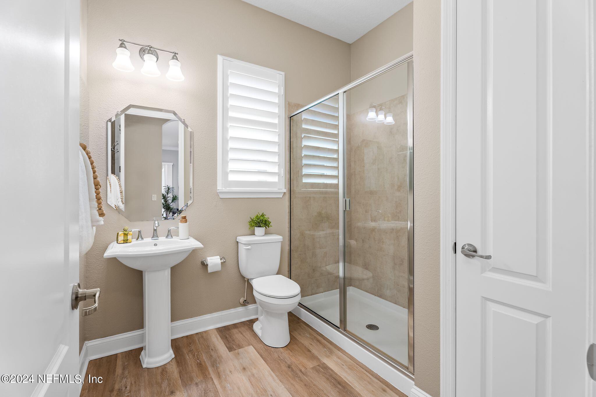 206 Medio Drive St. Augustine, FL 32095 - Photo 22 of 57 a bathroom with a sink a toilet and shower