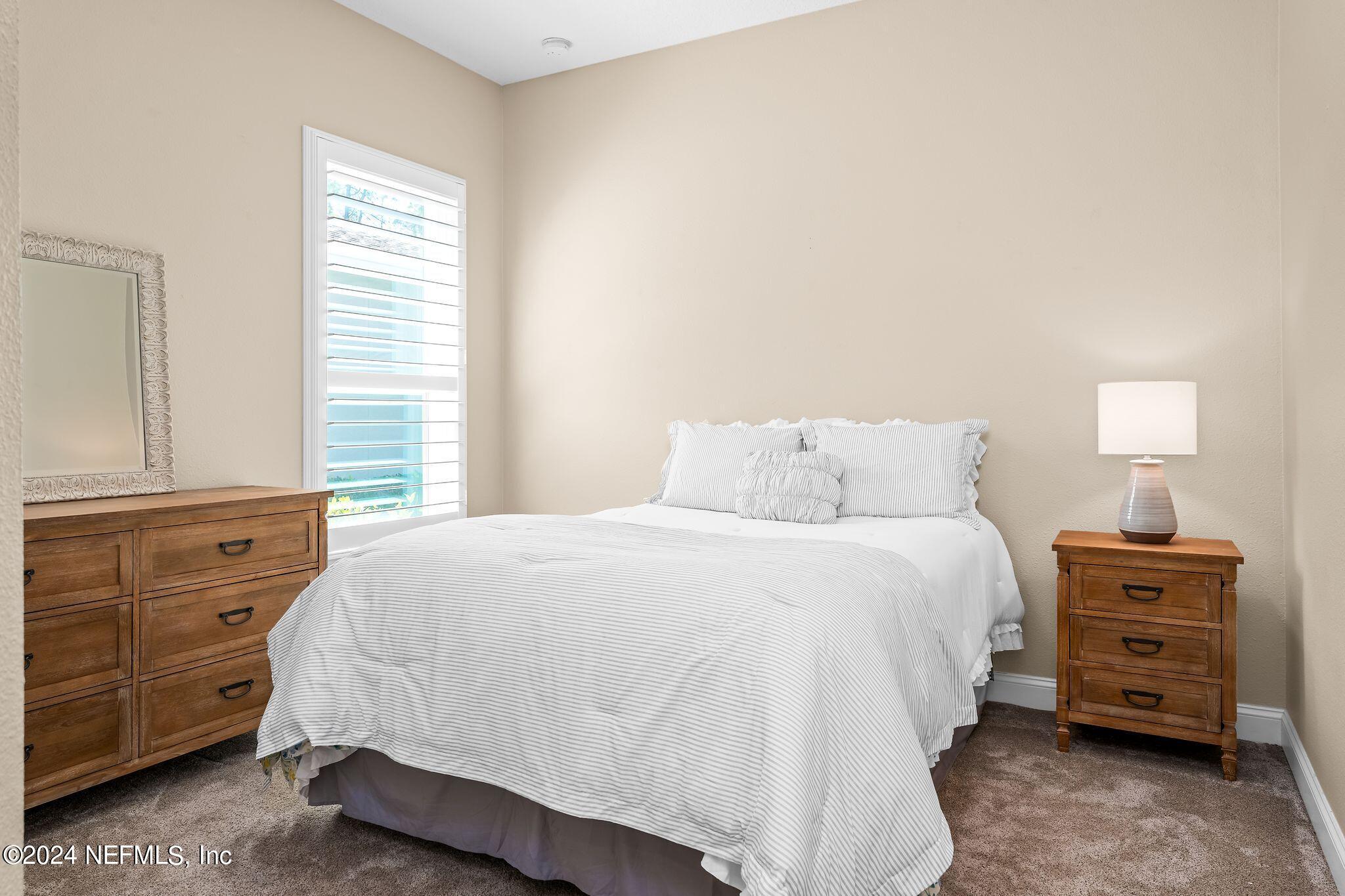 206 Medio Drive St. Augustine, FL 32095 - Photo 23 of 57 a bedroom with a bed and a window