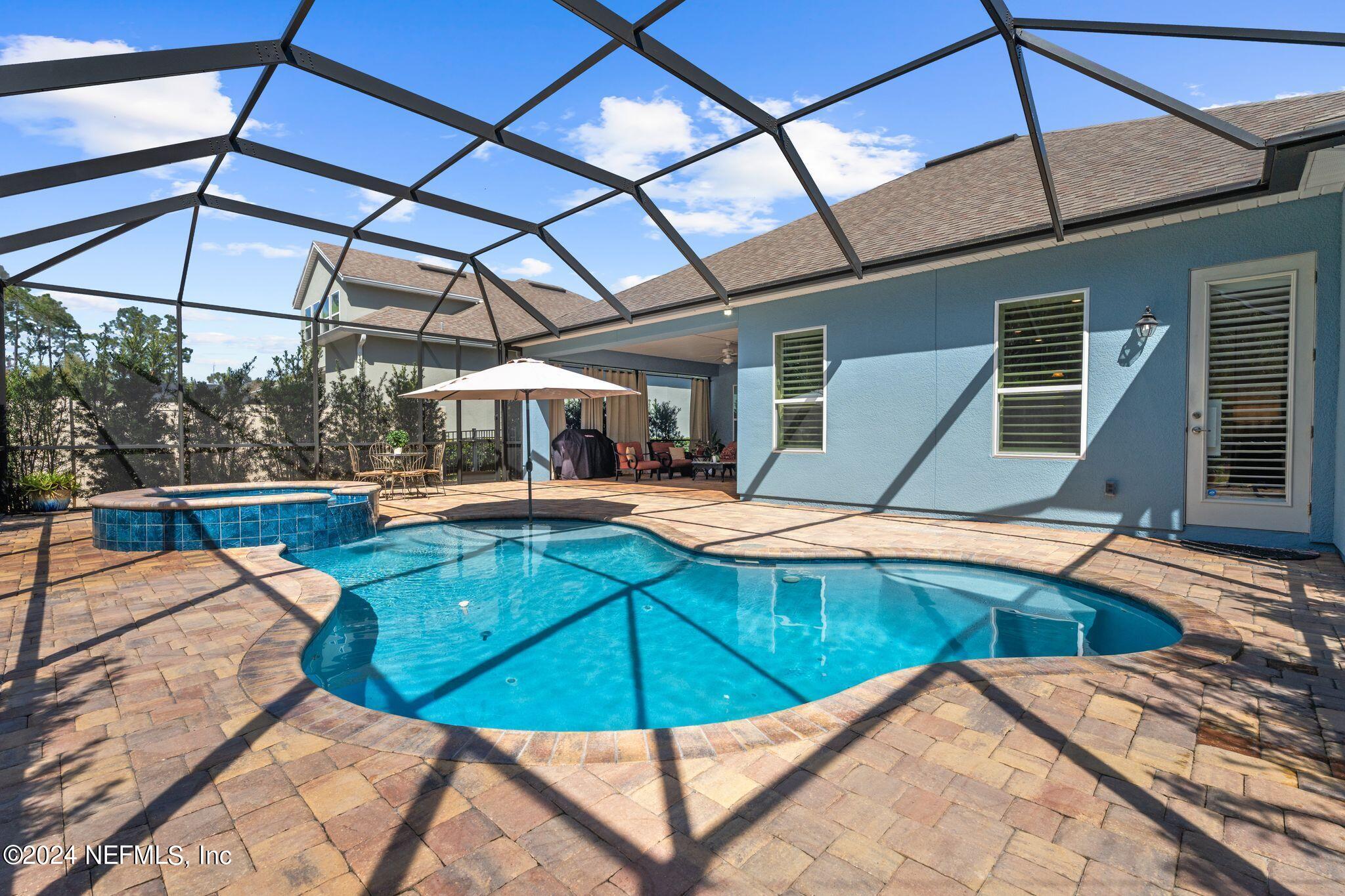 206 Medio Drive St. Augustine, FL 32095 - Photo 28 of 57 a view of a swimming pool with a lounge chairs