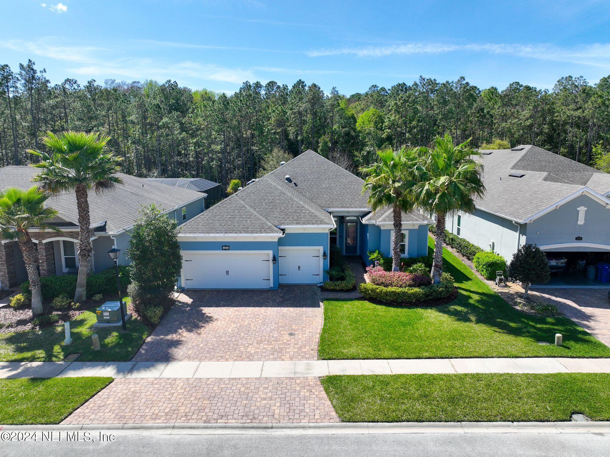 206 Medio Drive St. Augustine, FL 32095 - Photo 33 of 57 a front view of a house with a yard and garage