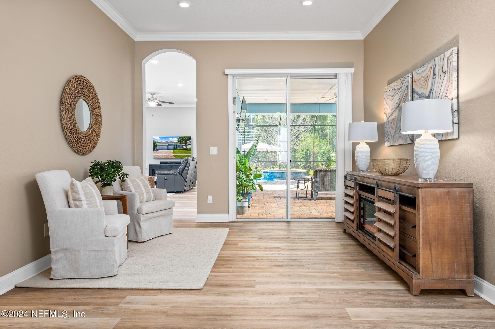 206 Medio Drive St. Augustine, FL 32095 - Photo 4 of 57 a living room with furniture a fireplace and a large window