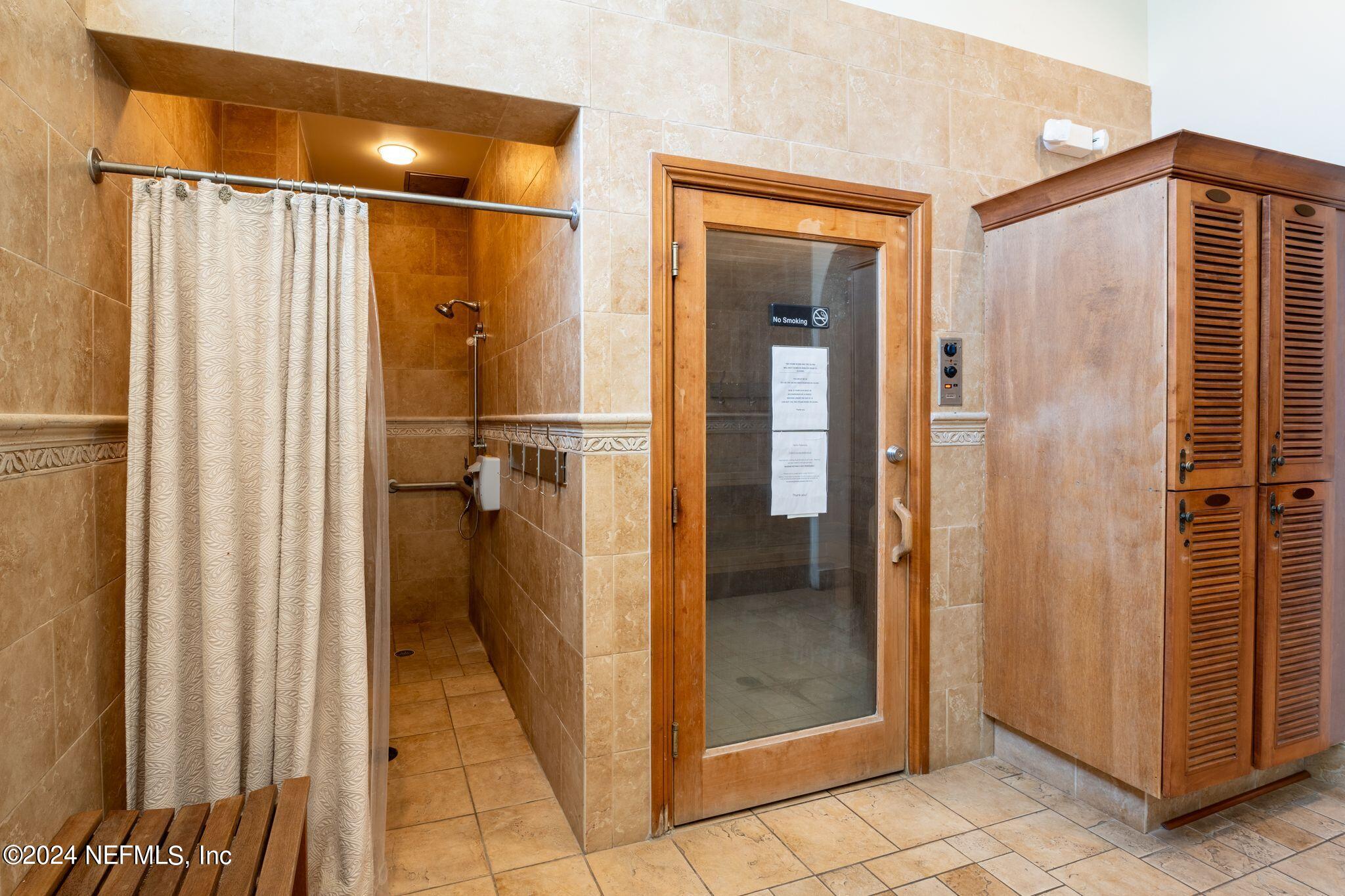 206 Medio Drive St. Augustine, FL 32095 - Photo 56 of 57 a bathroom with a shower and a glass door